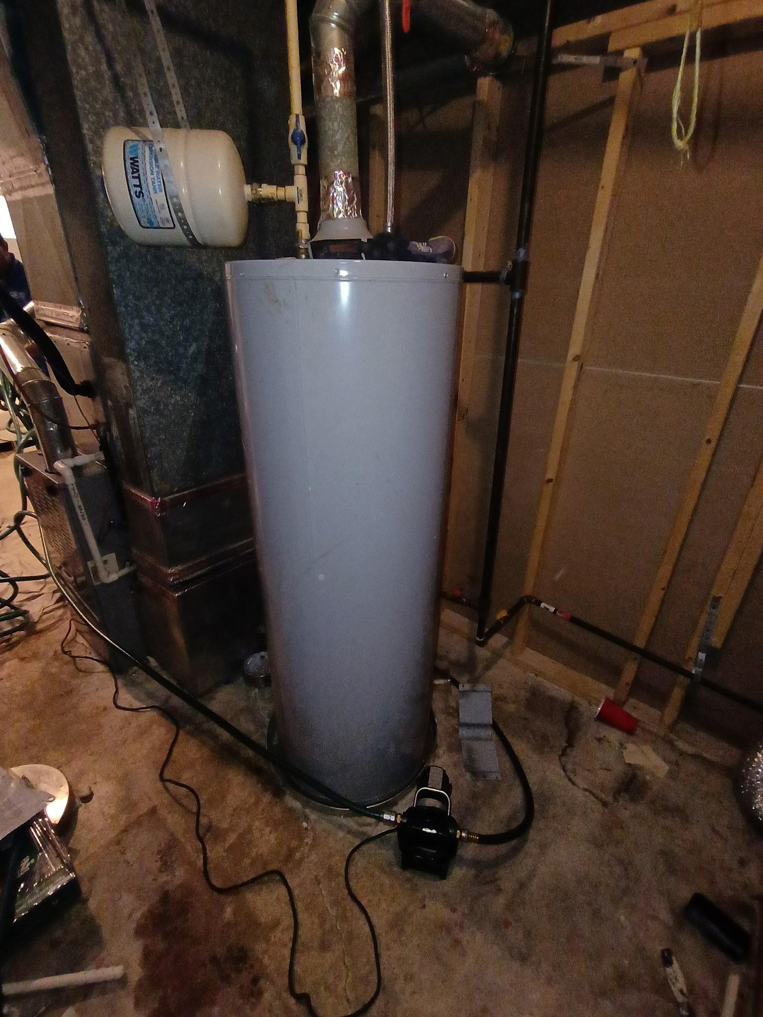 Before: A 40-gallon Bradford White gas water heater replacement in Temple Hills with new copper connections, an expansion tank and an upgraded metal flue path.